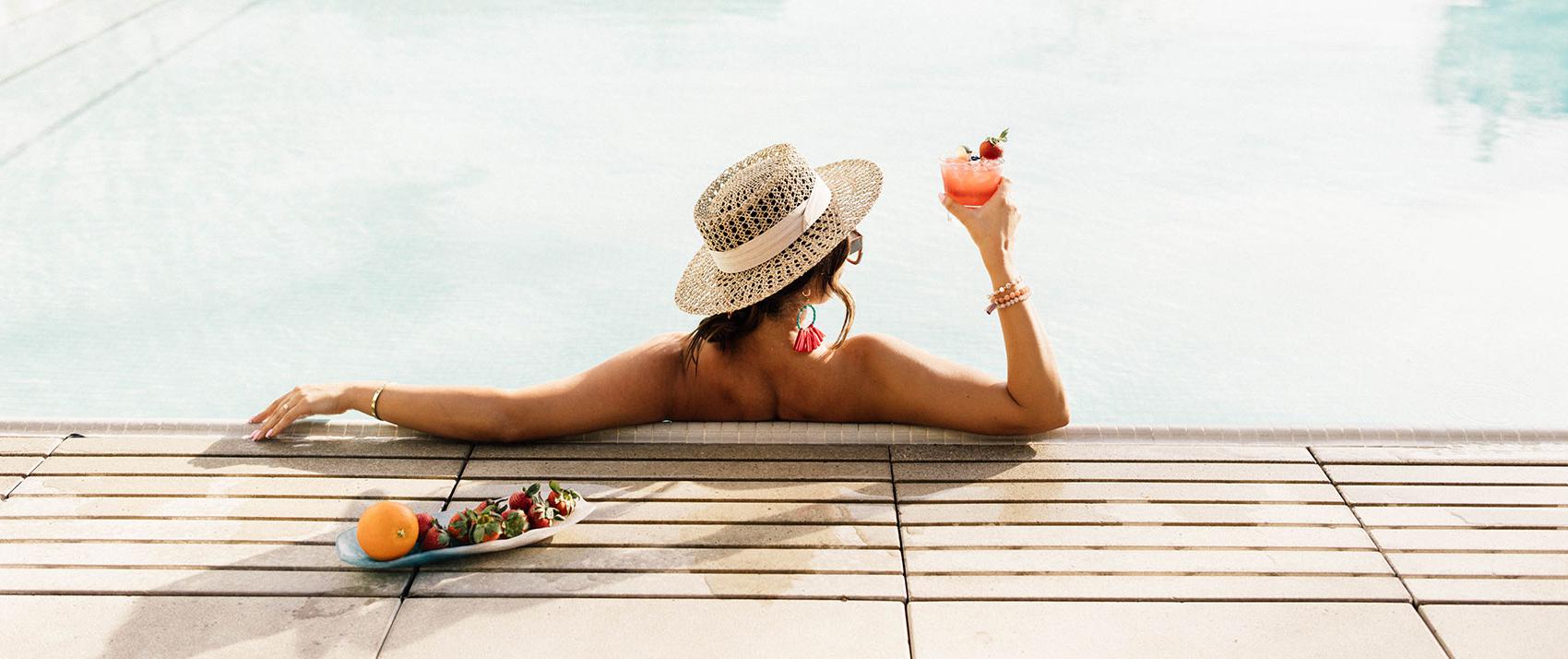 woman in sawyer pool with cocktail